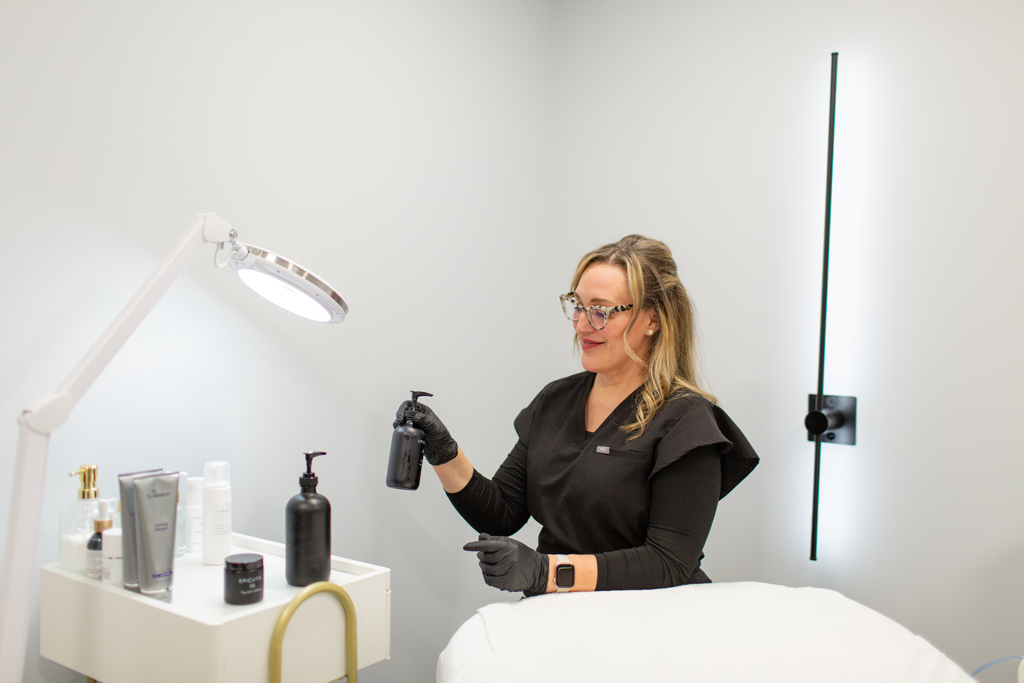 Clinical Aesthetician Saasha preparing for a client