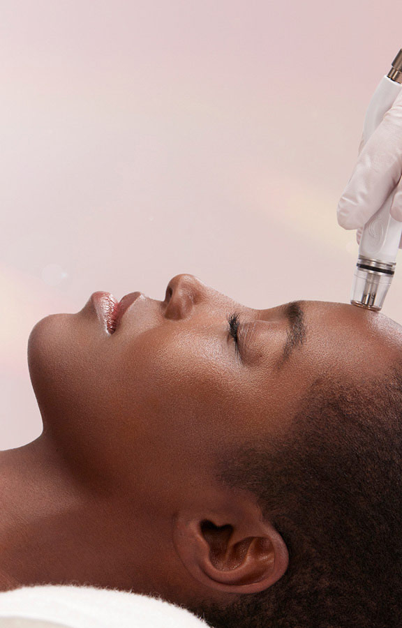 Woman relaxing while receiving DiamondGlow Signature Facial